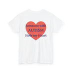 White t-shirt, back printed printed with a large salmon-red heart made of jigsaw puzzle pieces, lettered across it "Someone with AUTISM Stole my Heart", shown from another angle.