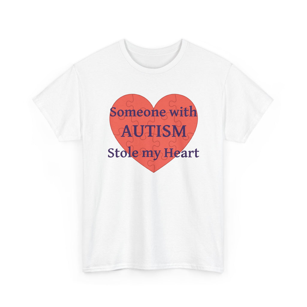 White t-shirt printed with a large salmon-red heart made of jigsaw puzzle pieces, lettered across it "Someone with AUTISM Stole my Heart", shown flat from another angle.