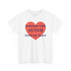 White t-shirt printed with a large salmon-red heart made of jigsaw puzzle pieces, lettered across it "Someone with AUTISM Stole my Heart", shown flat from another angle.