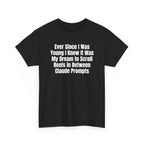 Black t-shirt printed with "Ever since i was young i knew it was my dream to scroll reels in between Claude prompts", shown flat from another angle.