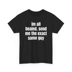 Black t-shirt printed with "im all healed. send me the exact same guy", shown flat from another angle.
