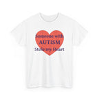 White t-shirt printed with a large salmon-red heart made of jigsaw puzzle pieces, lettered across it "Someone with AUTISM Stole my Heart", shown flat from another angle.