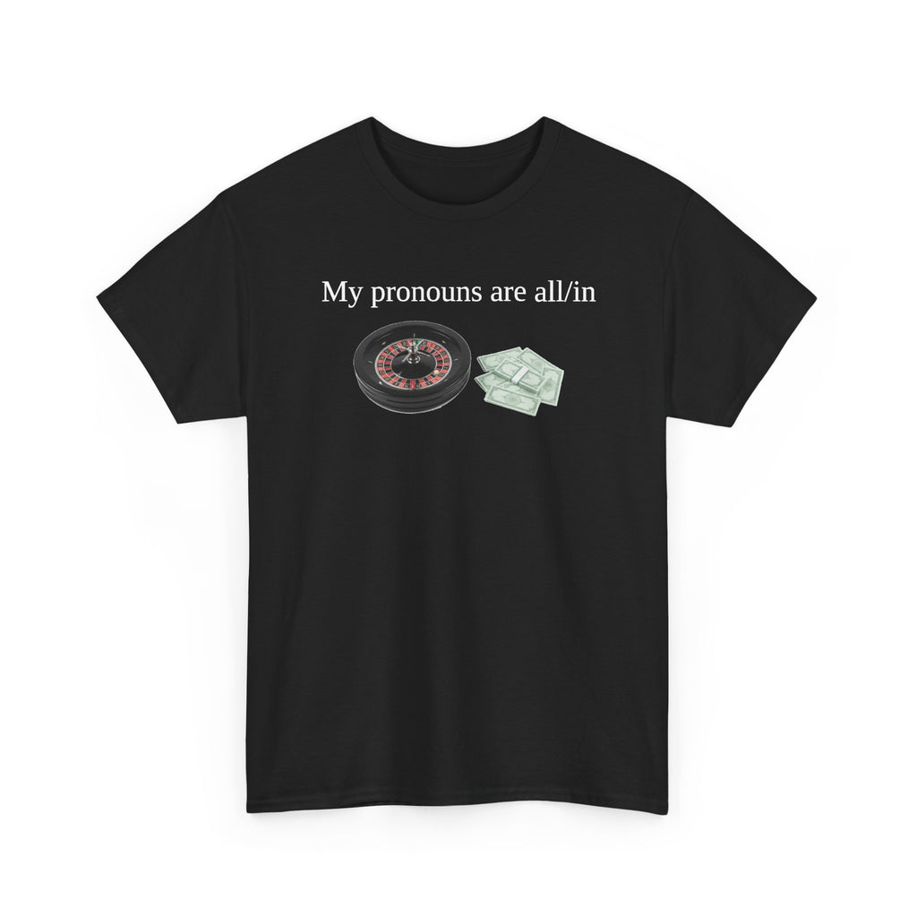 Black t-shirt printed with "My pronouns are all/in" in serif type above a roulette wheel and a fanned pile of banknotes, shown flat from another angle.