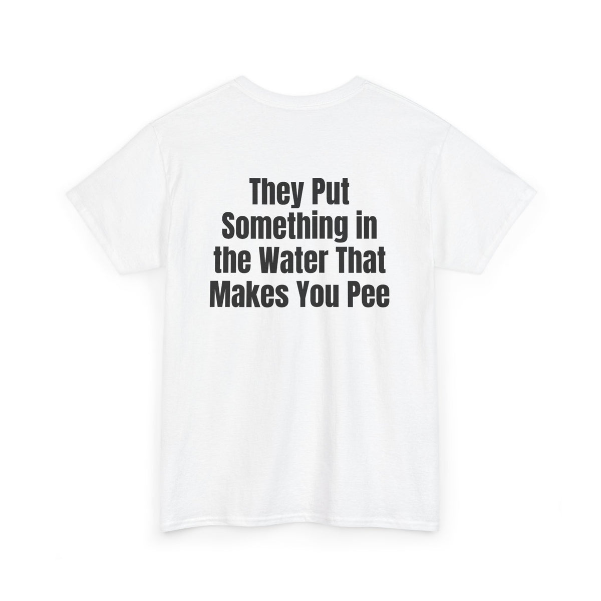 White t-shirt, back printed with "They put something in the water that makes you pee", shown from another angle.