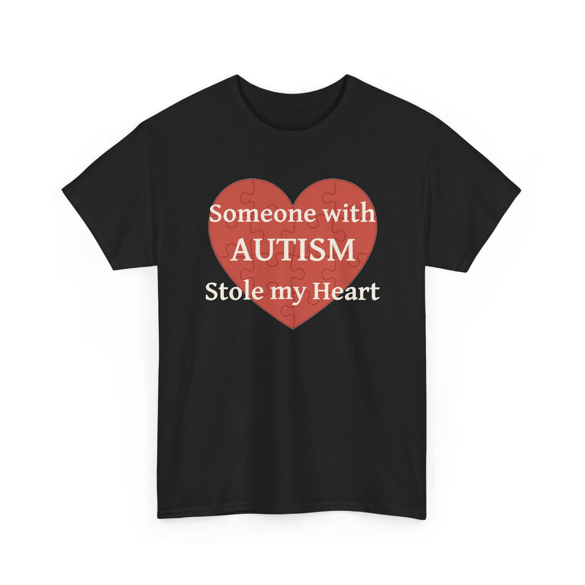 Black t-shirt printed with a large salmon-red heart made of jigsaw puzzle pieces, lettered across it "Someone with AUTISM Stole my Heart", shown flat from another angle.