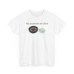 White t-shirt printed with "My pronouns are all/in" in serif type above a roulette wheel and a fanned pile of banknotes, shown flat from another angle.