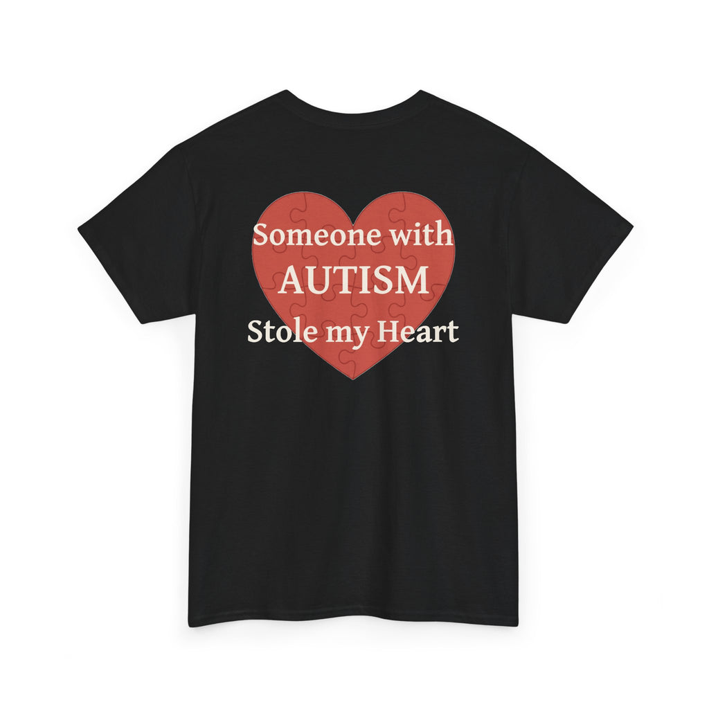 Black t-shirt, back printed printed with a large salmon-red heart made of jigsaw puzzle pieces, lettered across it "Someone with AUTISM Stole my Heart", shown from another angle.