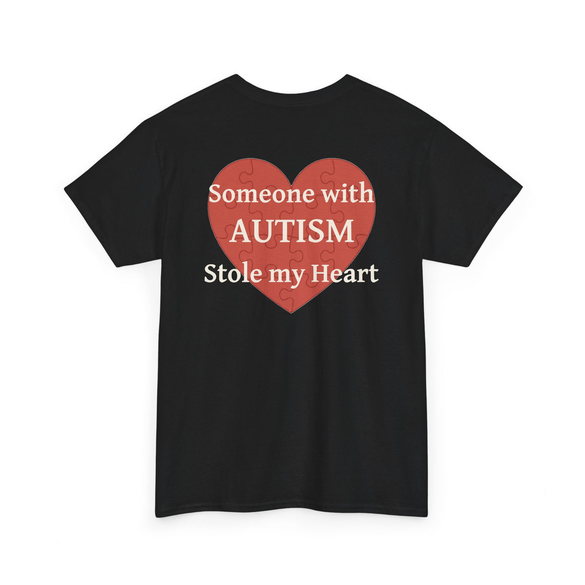 Black t-shirt, back printed printed with a large salmon-red heart made of jigsaw puzzle pieces, lettered across it "Someone with AUTISM Stole my Heart", shown from another angle.