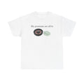 White t-shirt printed with "My pronouns are all/in" in serif type above a roulette wheel and a fanned pile of banknotes.