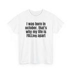 White t-shirt printed with "I was born in october. that's why my life is FALLing apart", shown flat from another angle.